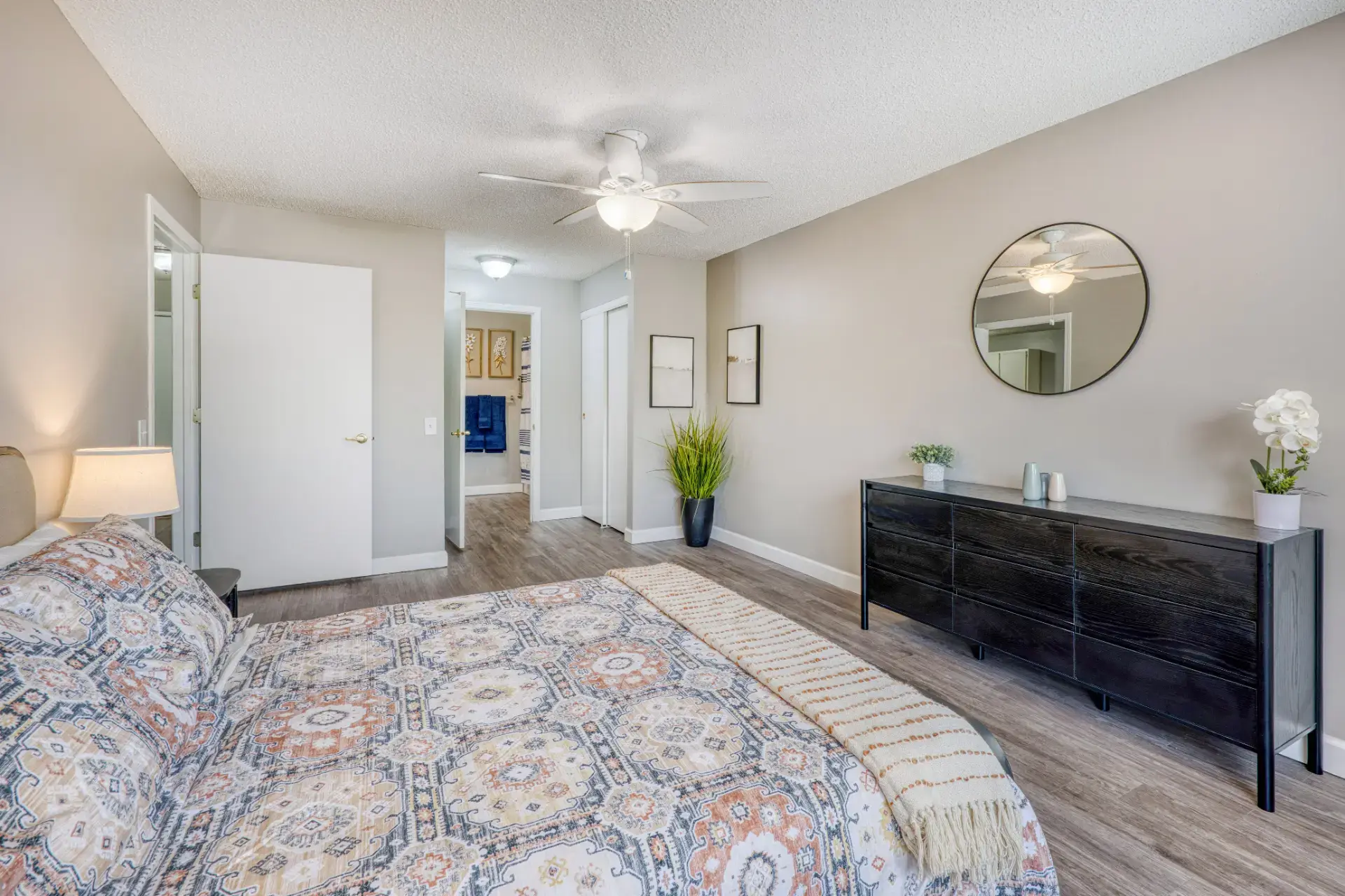 Furnished bedroom with lighting and floral decor.